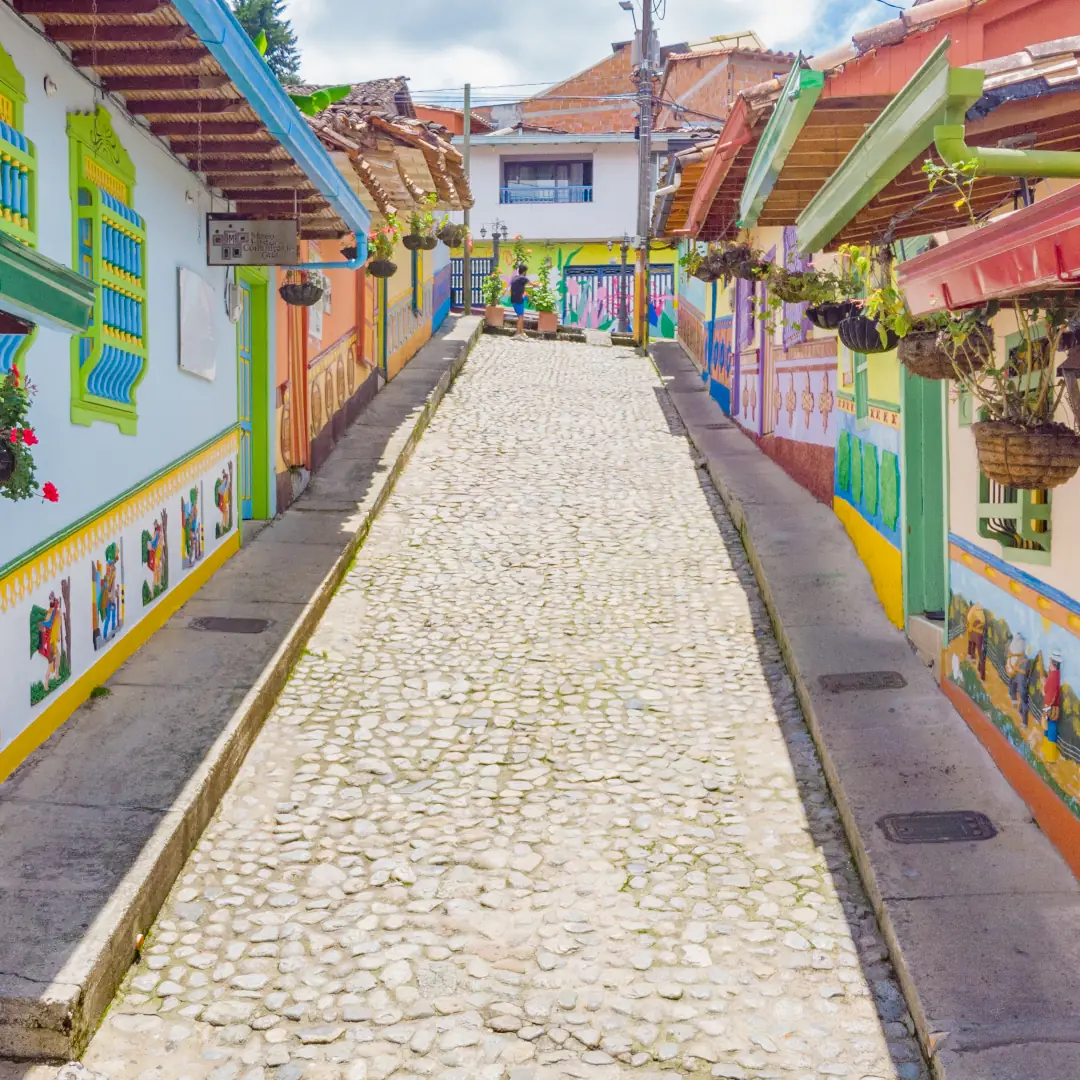 Calle de Guatapé con fachadas de colores y zócalos pintados.